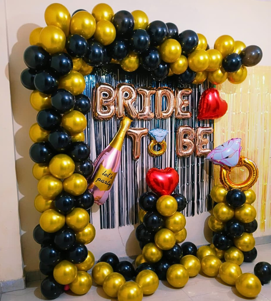 black and golden bride to be arch decor